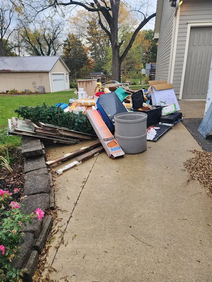 Dumpster being loaded with debris for Roofing Dumpster Rental in Charlotte